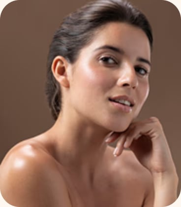 Woman with bare shoulders posing against a brown backdrop
